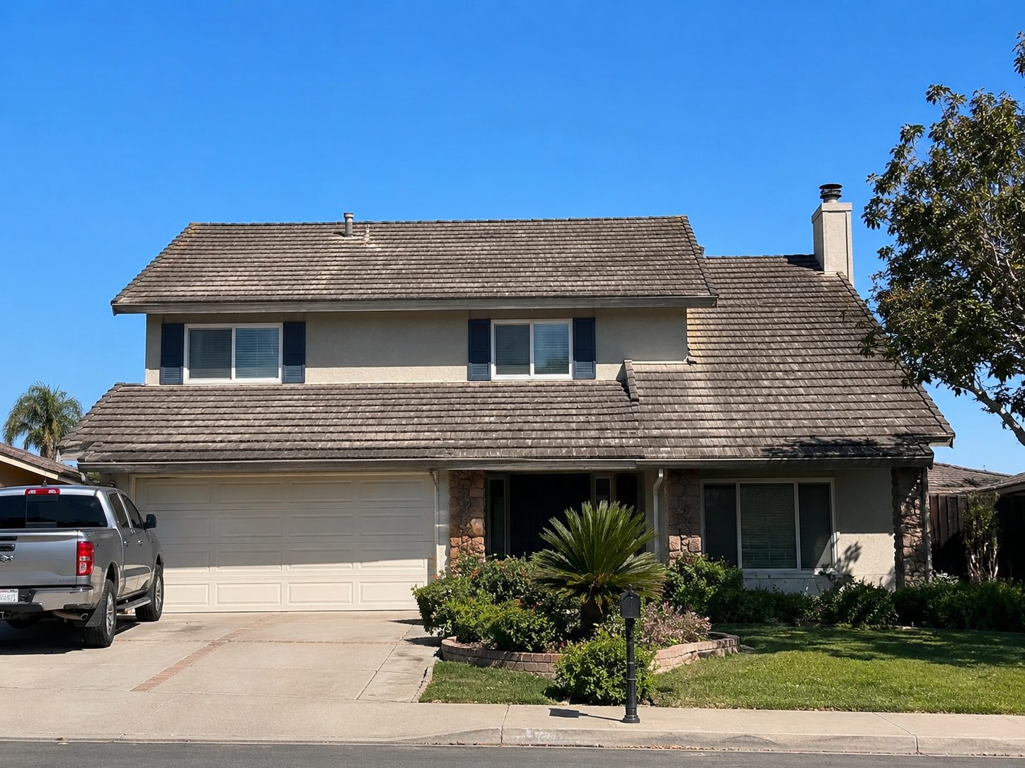 Weathered grey wood shake roof over a gable elevation, thinning at the ridge